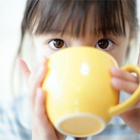 Japanese girl dinking tea with looking at camera